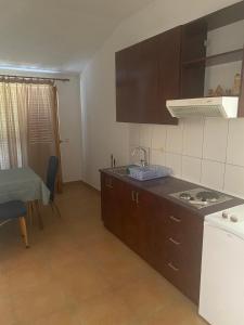 a small kitchen with a sink and a stove at Green Olive 3 in Budva
