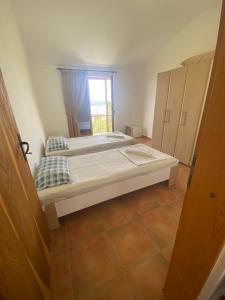 two beds in a room with a window at Green Olive 3 in Budva