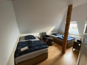 a bedroom with two beds and a ladder at MWM-Pension-Hotel in Meine
