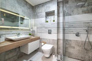 a bathroom with a shower and a toilet and a sink at Boutique 1 bedroom apartment with Private Parking and Port View in Varna City +43 photos