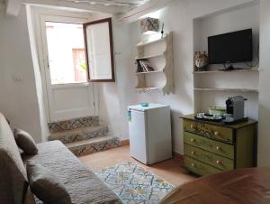 a living room with a small refrigerator and a window at Erice Appartamenti in Erice