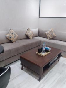 uma sala de estar com um sofá e uma mesa de centro em Hassan em Rabat
