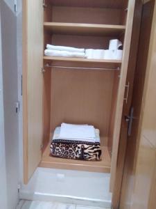 a cabinet with some towels in a bathroom at Hassan in Rabat