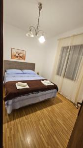 a bedroom with a bed with two towels on it at Kuća NIKA in Tribunj +9 photos