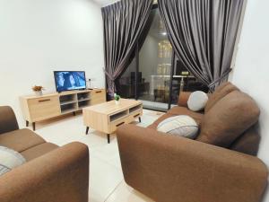 a living room with two couches and a tv at SoulHealingPlace Galacity 2BR 2Bed Apartment in Kuching