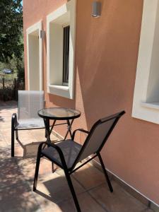 a table and a chair sitting on a patio at Casa Teresi Thassos in Prinos