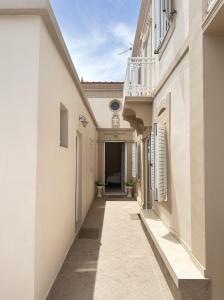an alleyway in a building with white walls at Elia Old Mansion in Malona Village