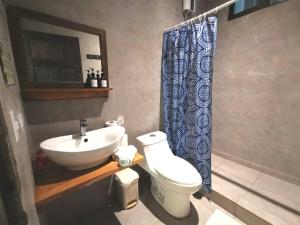 a bathroom with a sink and a toilet and a shower at Riverside Apartments - Walk to the Beach in Santa Teresa! Newly Renovated! in Santa Teresa Beach