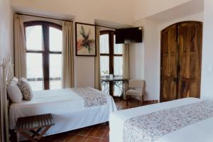 Postel nebo postele na pokoji v ubytování Hacienda San Nicolas de las Fuentes