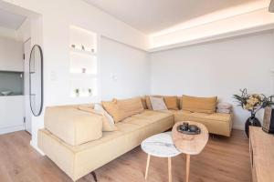 a living room with a couch and a table at M13-Sea View in Porto Rafti