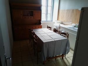 a kitchen with a table and chairs and a sink at Sainte Eulalie source de la loire in Sainte-Eulalie +2 photos