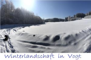 a field covered in snow with the words winter landscape in vog at Adam & Eva Gasthof Paradies mit Hotel in Vogt
