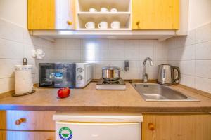 a kitchen counter with a sink and a mixer at Corvin Hotel Budapest Residence in Budapest