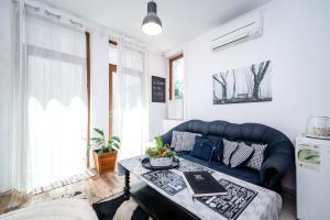a living room with a blue couch and a table at Bulrock Residance in Sofia +60 photos