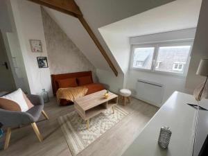 a living room with a couch and a bed at Appartement cosy centre ville in Avranches