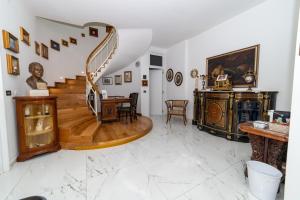a living room with a staircase and a table at La Villa Del Senatore in Gravina in Puglia