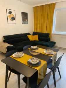 a living room with a table and a couch at Tabago Studio 1 Opole, Kośnego in Opole