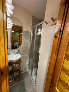 a bathroom with a sink and a mirror at Maison Le Pommier in Morgex +17 photos