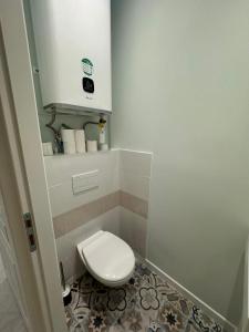 a small bathroom with a toilet and a sink at Maison entre Terre et Mer in Curzon +12 photos