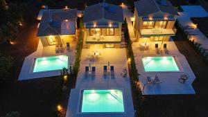 an aerial view of a house with two swimming pools at Anmaria Luxury in Lefkada