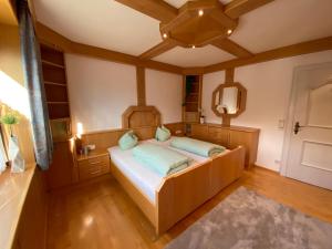 a bedroom with a bed and a mirror at Ferienhaus Schaiter - Ganzes Haus mit Garten und gratis Parkplatz in Innsbruck