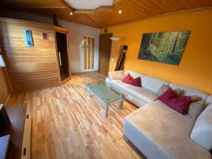 a living room with a couch and a table at Ferienhaus Schaiter - Ganzes Haus mit Garten und gratis Parkplatz in Innsbruck +28 photos