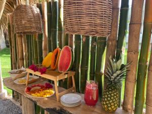 a table with a tray of fruit and a pineapple at Samo Eco Lodge in Las Terrenas