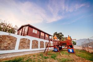 a playground with a house on top of a building at Casa La Loma in Granada