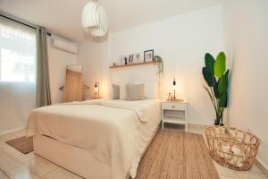 a white bedroom with a bed and a chair at Ocean view perfect sunset apartment, 4 rooms 137m2, WiFi & BBQ in San Miguel de Abona +37 photos