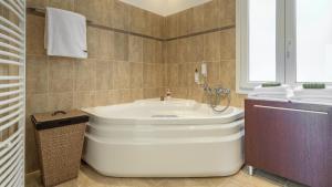 a bathroom with a white tub and a sink at Villa Marisol in Pollonia +46 photos