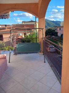a balcony with a swing and a view of a city at Maria s Apartment in Tertenìa