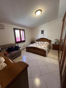 a bedroom with a bed and a living room at Maria s Apartment in Tertenìa