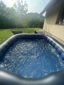 a hot tub with blue water in a backyard at Robinson "Mountain getaway" for Rest and Recreation sorrounded by Nature-PET FRIENDLY in Macelj