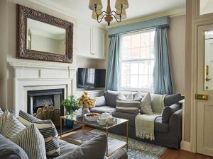 a living room with a couch and a fireplace at Dolls House - Luxury Townhouse *sleeps 10* in Henley on Thames