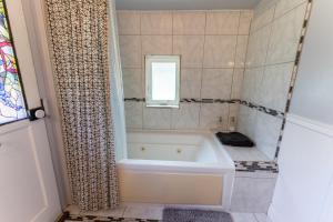 a white bath tub in a bathroom with a window at Little Red Caboose in Oakhurst