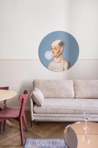 a room with a couch and a painting of a nun at UP'arts in Wrocław
