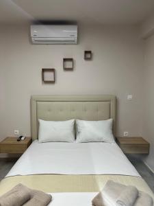 a bedroom with a large white bed with two pillows at F&M House Semi Basement in Sarti