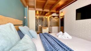 a bedroom with a bed with a tv on the wall at The Cliffs - MarCastelos in Viveiro