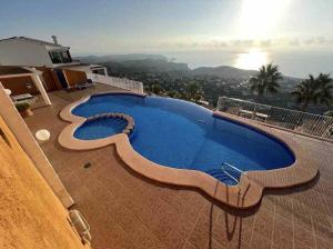 a large swimming pool on the roof of a house at Spectacular Panorama in Benitachell