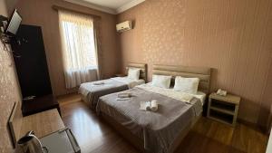 Postel nebo postele na pokoji v ubytování Hotel RichI G A