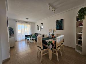 a living room with a table and chairs and a couch at Apartament Carina in Mar de Cristal