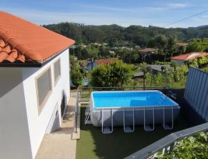 a swimming pool on the balcony of a house at Casa do Pereiro in Vieira do Minho