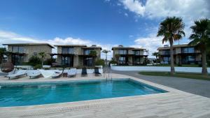 a swimming pool in front of a resort at Sunshine Villa: Getaway in Kallithea in Kallithea Halkidikis