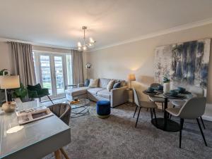 a living room with a couch and a table at 40 Handley's Elite Apartment in Hemel Hempstead