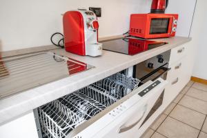 a kitchen with a red appliance on a counter at Dolce Teresa Apartment in Mandello del Lario +35 photos