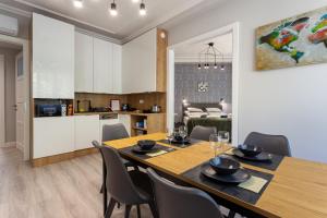 a dining room and kitchen with a table and chairs at Buda Castle Serpentine Apartments in Budapest
