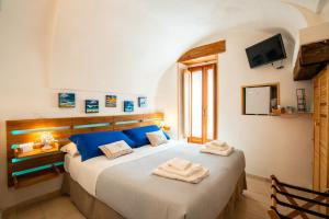 Postel nebo postele na pokoji v ubytování L'ARCO ANTICO - Una Casa sul Mare
