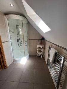 a bathroom with a shower and a bench in it at Boutique Shrewsbury Rooms in Shrewsbury