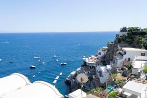 an aerial view of a city with boats in the water at o' mar - Amalfi Coast Suite in Praiano