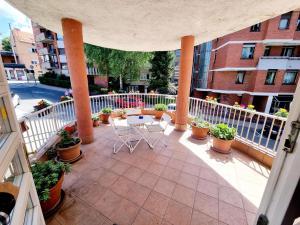 an outdoor patio with chairs and potted plants at nafaka apartment 90m2 in Sarajevo +2 photos